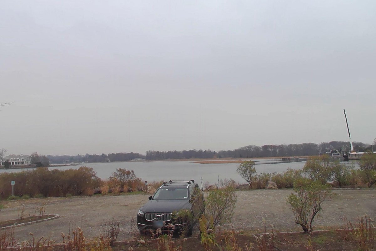 The gravel lot and the water at Mill Pond